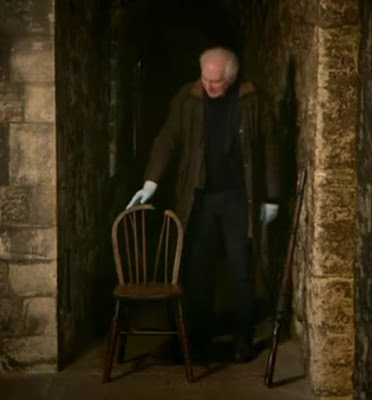 Screenshot of Dan Cruickshank with the chair upon which Josef Jakobs faced the firing squad on 15 August 1941. - Majesty & Mortar: Britain