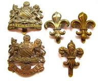Badges of the Manchester Regiment. In 1923, the badges changed to the fleur-de-lis.