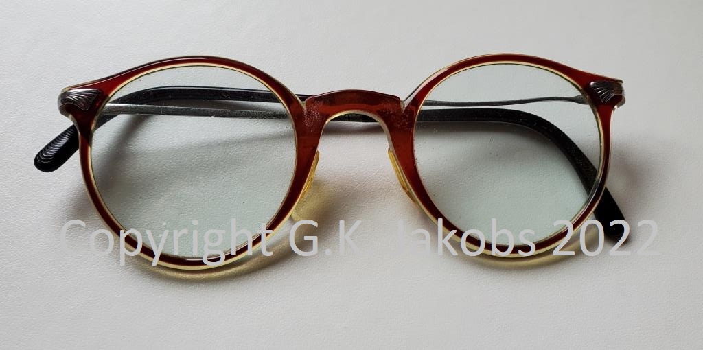 Horn-rimmed reading glasses of Josef Jakobs. You can see that one of the arms is warped slightly. (photograph copyright 2022 by G.K. Jakobs)