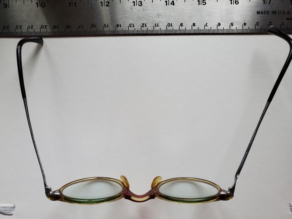 Horn-rimmed reading glasses of Josef Jakobs. The arm on the right is warped and does not touch the paper. (photograph copyright 2022 by G.K. Jakobs)