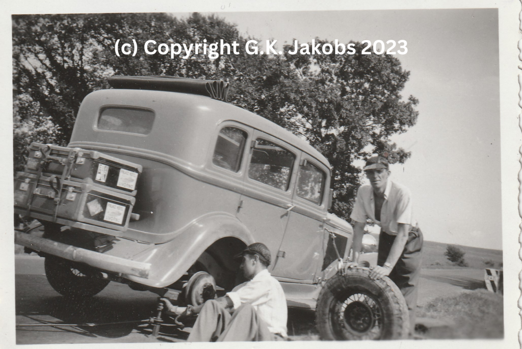 Josef Jakobs (standing) and the Mystery Man (possibly Werner Adolf Goldstein) changing a vehicle tire in July/August 1940. Location unknown. Copyright G.K. Jakobs 2023.