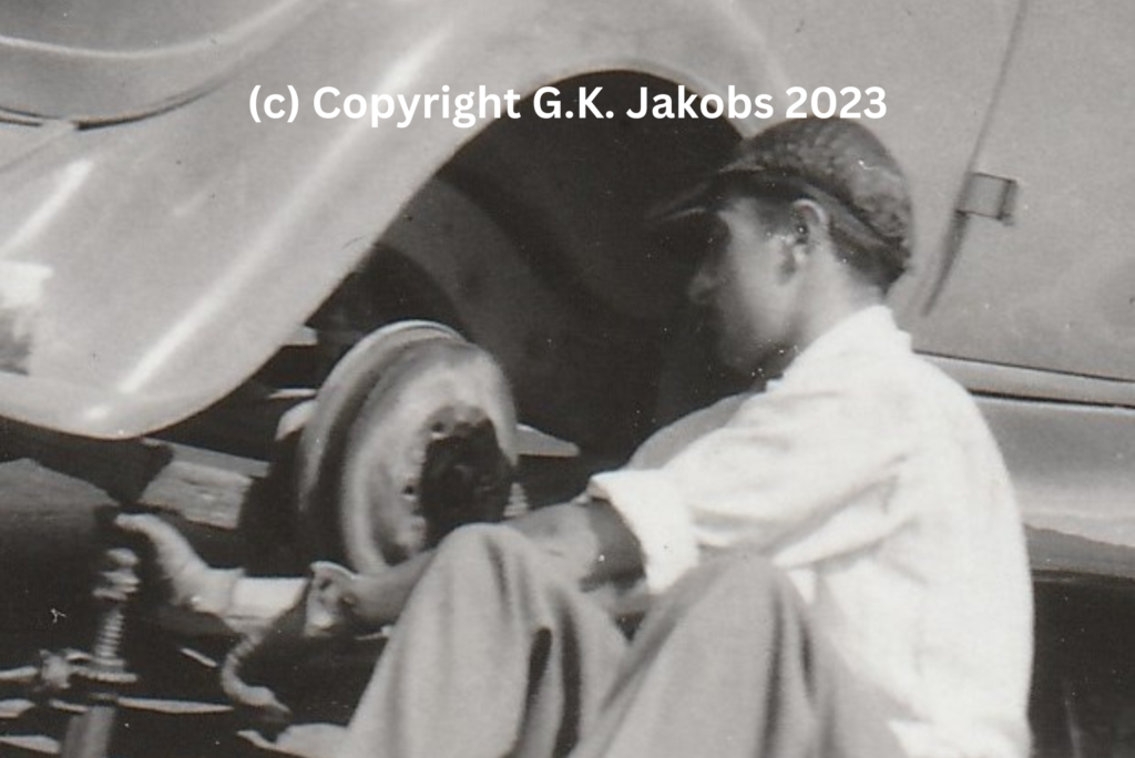 Close-up of the Mystery Man (possibly Werner Adolf Goldstein) changing a vehicle tire in July/August 1940. Location unknown. Copyright G.K. Jakobs 2023.